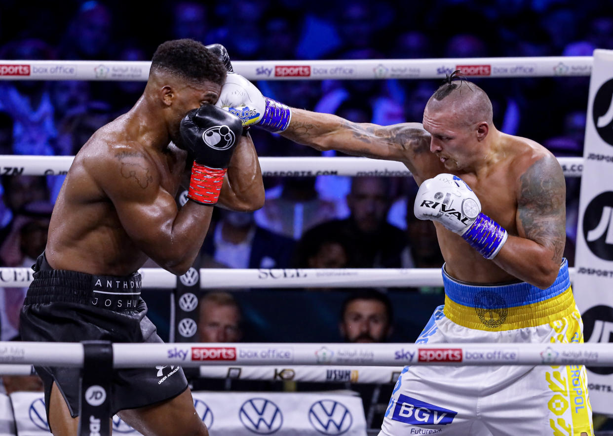 JEDDAH, SAUDI ARABIA - AUGUST 20: Oleksandr Usyk of Ukraine (R) in action against Anthony Joshua (L) of Great Britain during boxing rematch under the name of 
