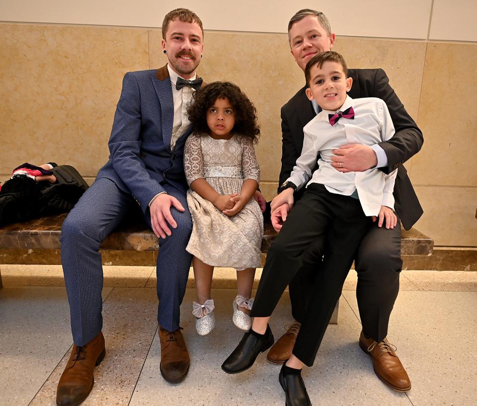 Sheldon and Bill Vigeant of Shrewsbury, wait for new daughter Paige's adoption ceremony with their son, Liam, 8, whom they adopted in 2016, during Friday's 20th annual National Adoption Day at Worcester Juvenile Court.