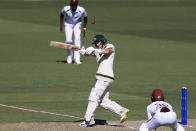 Australia's Marnus Labuschagne, center, plays a shot that will have him caught out by the West Indies on the first day of their cricket test match in Adelaide, Australia, Wednesday, Jan. 17, 2024. (AP Photo/James Elsby)