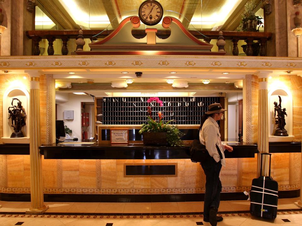 Shot of the lit up front desk area and room card wall.