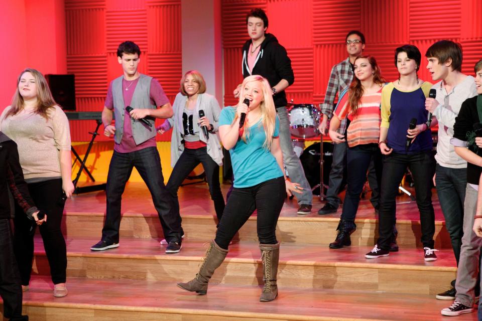 Harper Grae singing in the center of the "Glee Project" cast