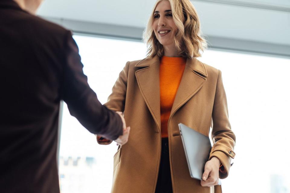 two business women shaking hands