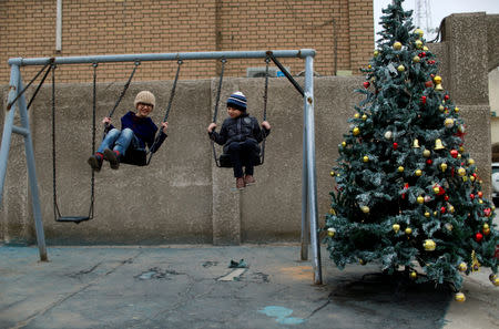 Iraqi Christians play outside St George Chaldean Catholic Church after a mass on Christmas in Baghdad, Iraq December 25, 2018. REUTERS/Thaier Al-Sudani