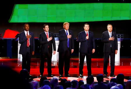 Republican U.S. presidential candidates (L-R) Dr. Ben Carson, U.S. Senator Marco Rubio, Donald Trump, Senator Ted Cruz and Governor John Kasich hold their hands over their hearts as they listen to the U.S. national anthem before the candidate debate sponsored by CNN in Houston, Texas, February 25, 2016. REUTERS/Mike Stone