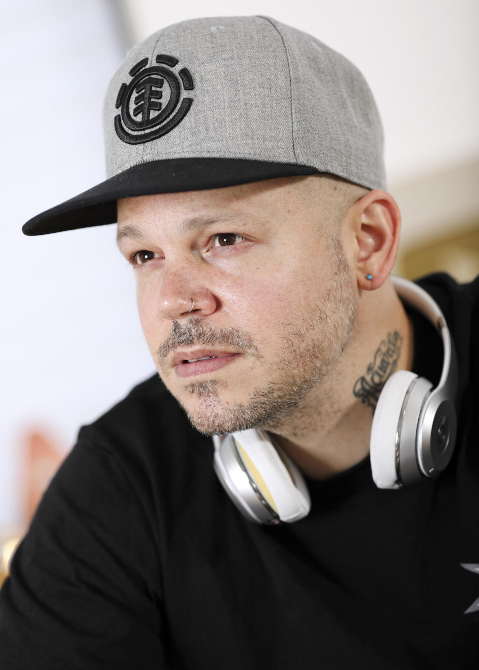 This July 12, 2019 photo shows Puerto Rican rapper, writer, and filmmaker René Pérez Joglar, known professionally as Residente, at his home in New York. Residente studied intensely with professors at Yale University and New York University to create his second solo project. The untitled album will be released in November. (Photo by Brian Ach/Invision/AP)