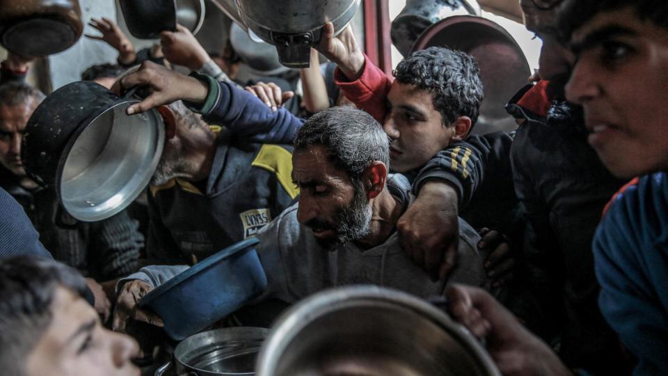 PHOTO: Palestinians collect aid food in Beit Lahia, in the northern Gaza Strip, Feb. 26, 2024. (AFP via Getty Images)