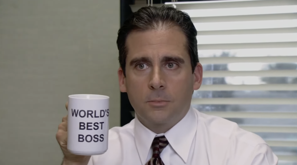 Michael Scott from "The Office" holding a mug labeled "WORLD'S BEST BOSS"