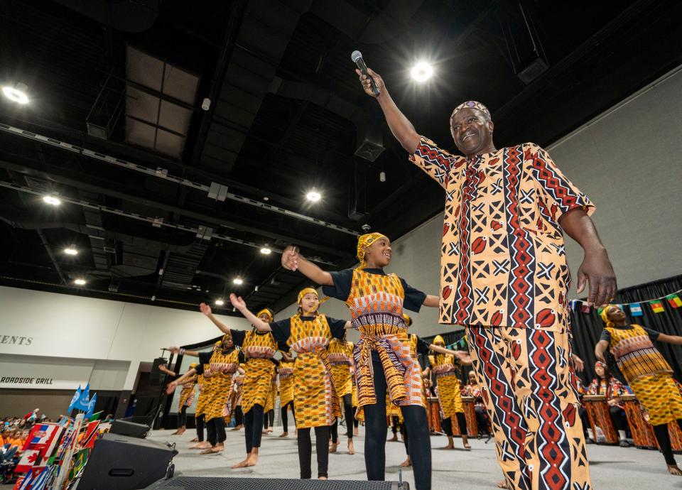 Lucky Diop, right, of Senegal, leads student African dancers at the Milwaukee Public Schools World Fair Thursday.