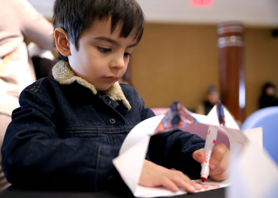 Wilder Heart, 5, makes a crown during the Noon Year's Eve Eve celebration at the Oklahoma City Museum of Art in Oklahoma City, Saturday, Dec. 30, 2023.