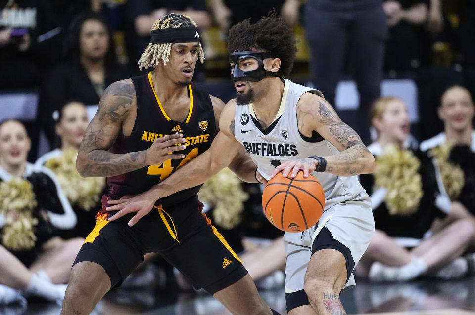 Colorado guard J'Vonne Hadley, right, drives past Arizona State guard Adam Miller, left, in the first half of an NCAA college basketball game Thursday, Feb. 8, 2024, in Boulder, Colo. (AP Photo/David Zalubowski)