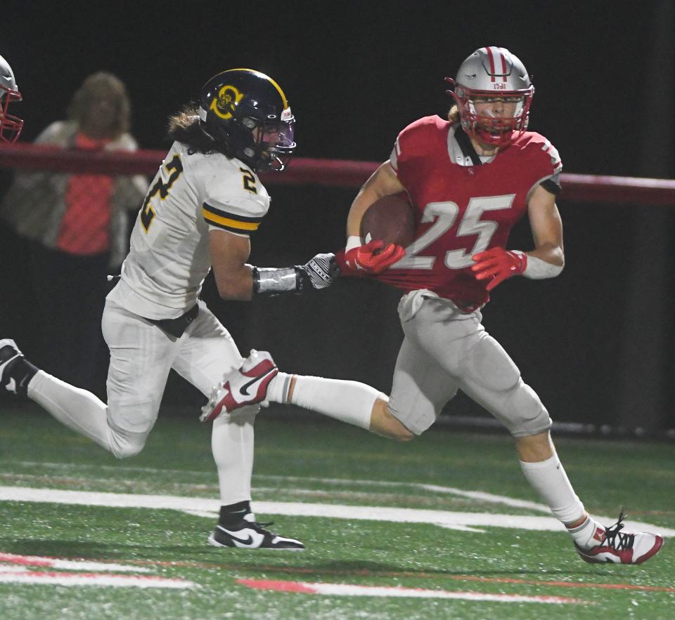 Dominic Gullace of Canandaigua breaks the tackle attempt from Amari Marianetti-Smith on his way to a punt return touchdown in the third quarter.