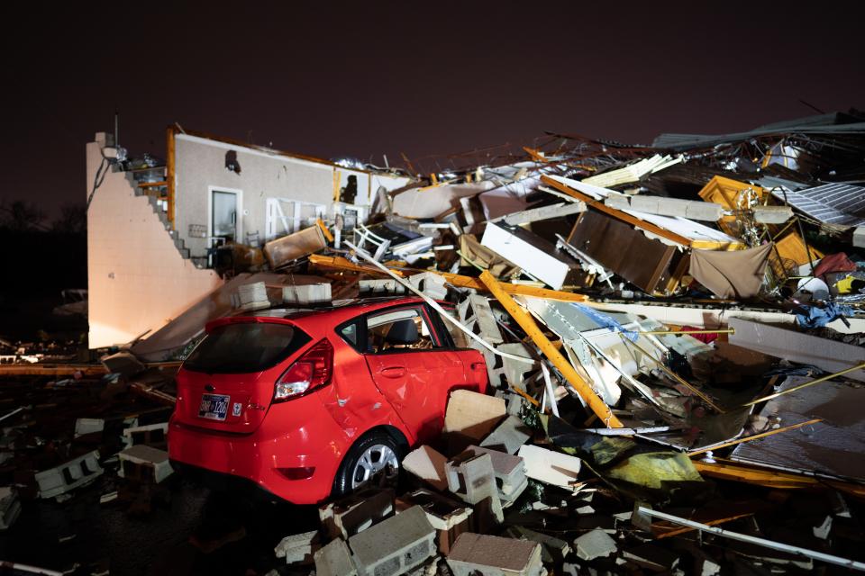 A car is buried under rubble on Main Street after a tornado hit Hendersonville, Tenn., Saturday, Dec. 9, 2023.