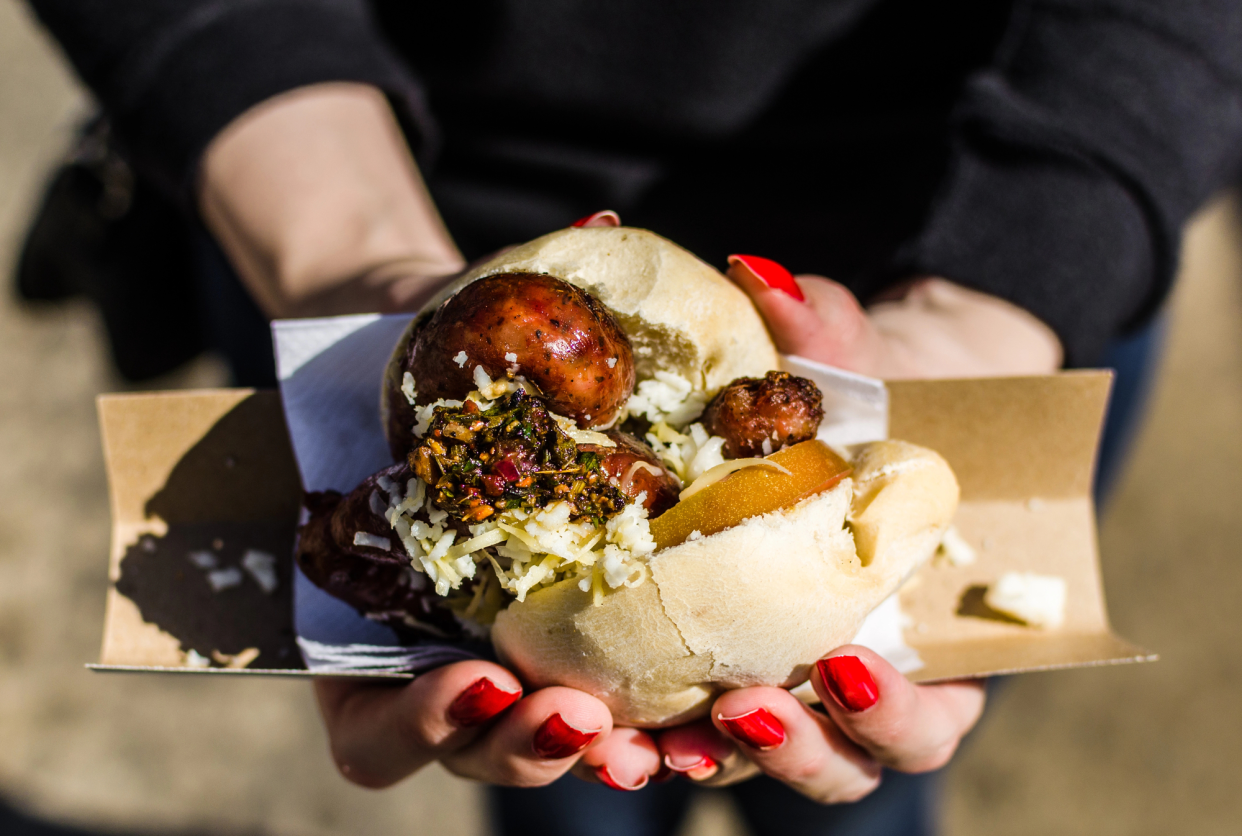 Top-View of Choripan Sandwich Being Held by a Woman, Outside, Buenos Aires, Argentina