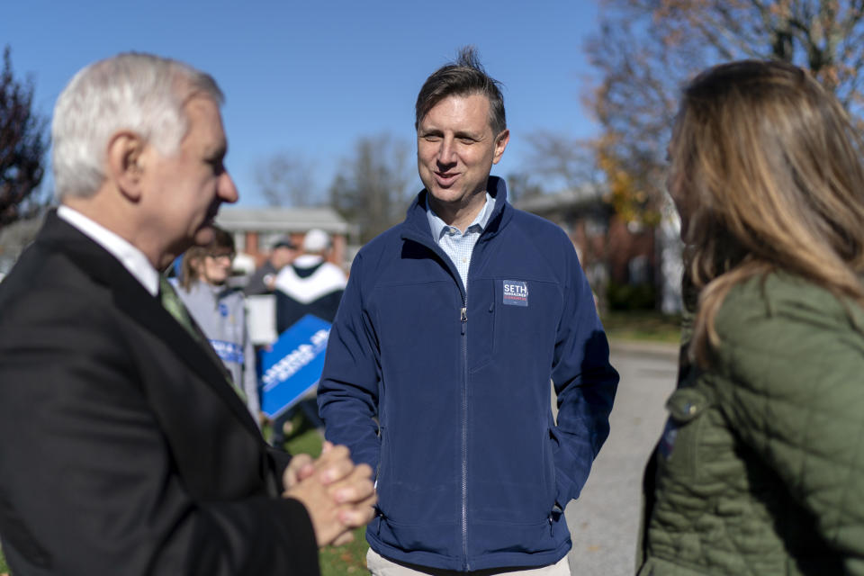 Rhode Island General Treasurer and Democratic candidate for the state's 2nd Congressional District, Seth Magaziner, center, and his wife, Julia McDowell, right, talk with Sen. Jack Reed, D-R.I., while greeting voters outside a polling site in Johnston, R.I., Tuesday, Nov. 8, 2022. (AP Photo/David Goldman)