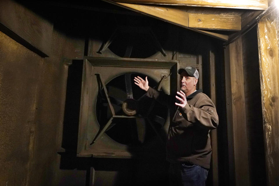 In a March 11, 2021 photo, potato farmer Brian Sackett describes his ventilation system at his farm in Mecosta, Mich. For generations, Sackett's family has farmed potatoes that are made into chips. About 25% of the nation's potato chips get their start in Michigan, which historically has had reliably cool air during September harvest and late spring but now is getting warmer temperatures. (AP Photo/Carlos Osorio)