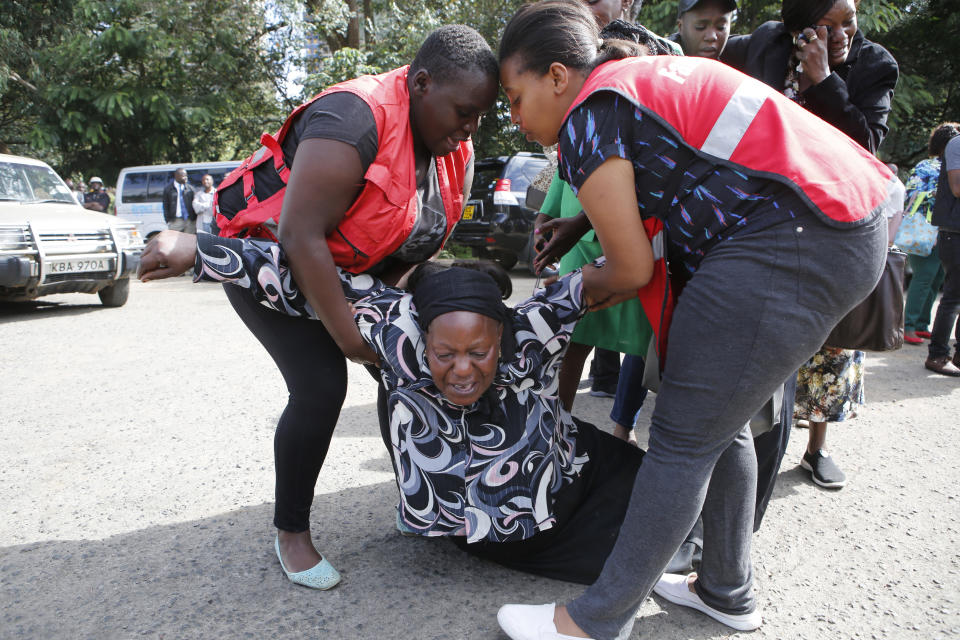 Kenyan Red Cross workers help a woman at the Chiromo Mortuary in Nairobi, Kenya, after she learned of a family member killed during the terrorist attack on Jan. 15, 2019, (Photo: Brian Inganga/AP)