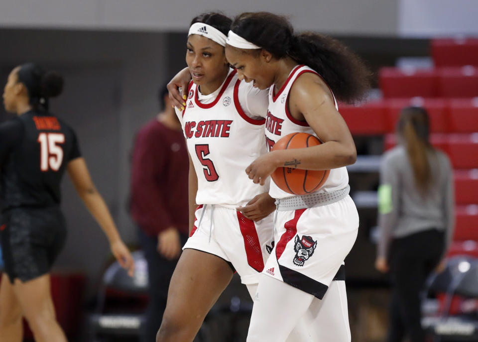 North Carolina State's Kayla Jones (25), right and Jada Boyd (5) walk off the court after an NCAA college basketball game against Virginia Tech, Sunday, Jan. 24, 2021 in Raleigh, N.C. (Ethan Hyman/The News & Observer via AP)