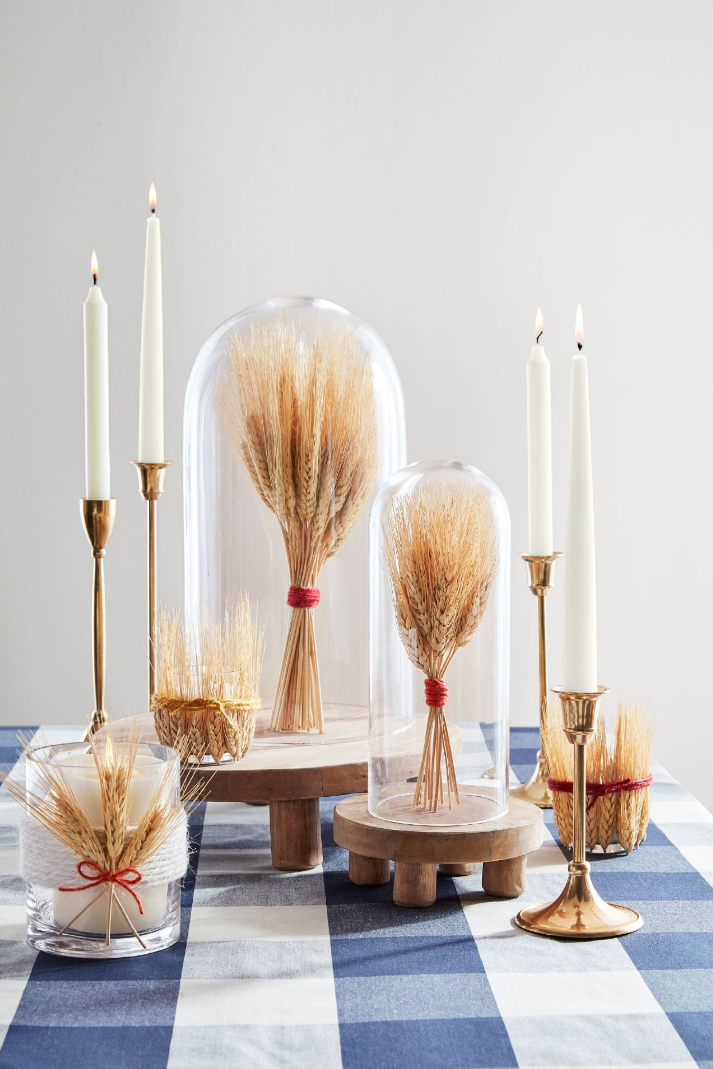 <p>If you're looking for a sophisticated farmhouse feel, these DIY wheat cloches are refined <em>and </em>natural touches.</p><p><strong>To make: </strong>Bundle a <a href="https://www.amazon.com/BD-Crafts-Natural-dried-sheaves/dp/B072KZHWXJ?tag=syn-yahoo-20&ascsubtag=%5Bartid%7C10050.g.2063%5Bsrc%7Cyahoo-us" rel="nofollow noopener" target="_blank" data-ylk="slk:small handful of wheat" class="link ">small handful of wheat</a> and tie with <a href="https://www.amazon.com/Vivifying-Natural-Crafts-Wrapping-Garden/dp/B07G54KP8D?tag=syn-yahoo-20&ascsubtag=%5Bartid%7C10050.g.2063%5Bsrc%7Cyahoo-us" rel="nofollow noopener" target="_blank" data-ylk="slk:twine" class="link ">twine</a>. Turn a cloche upside down and place the wheat inside, then top with base and invert. Add leftover snips of wheat to votive holders (securing with twine).</p><p><a class="link " href="https://www.amazon.com/Lights4fun-Inc-Cloche-Display-Bamboo/dp/B012SXD1XE?tag=syn-yahoo-20&ascsubtag=%5Bartid%7C10050.g.2063%5Bsrc%7Cyahoo-us" rel="nofollow noopener" target="_blank" data-ylk="slk:SHOP GLASS CLOCHES">SHOP GLASS CLOCHES</a></p>