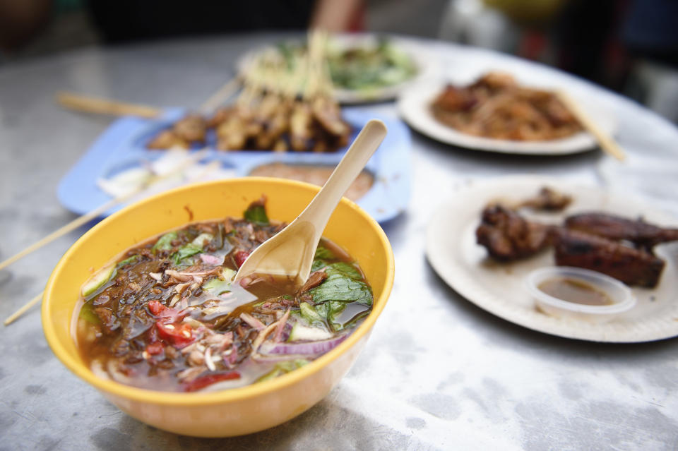 Plates and bowls of different Malaysian dishes