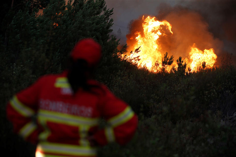 <p>Firefighters work to put out a forest fire next to the village of Macao, near Castelo Branco, Portugal, July 26, 2017. (Rafael Marchante/Reuters) </p>