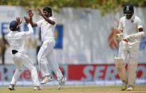 Cricket - Sri Lanka v India - First Test Match - Galle, Sri Lanka - July 27, 2017 - Sri Lanka's Nuwan Pradeep celebrates with his teammates after taking the wicket of India's Ravichandran Ashwin. REUTERS/Dinuka Liyanawatte