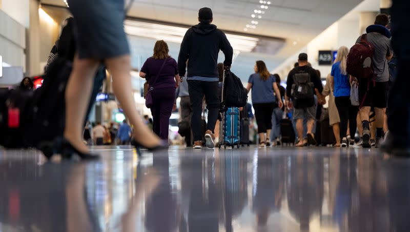 Travelers walk through the Salt Lake City International Airport in Salt Lake City on Tuesday, Aug. 2, 2022.