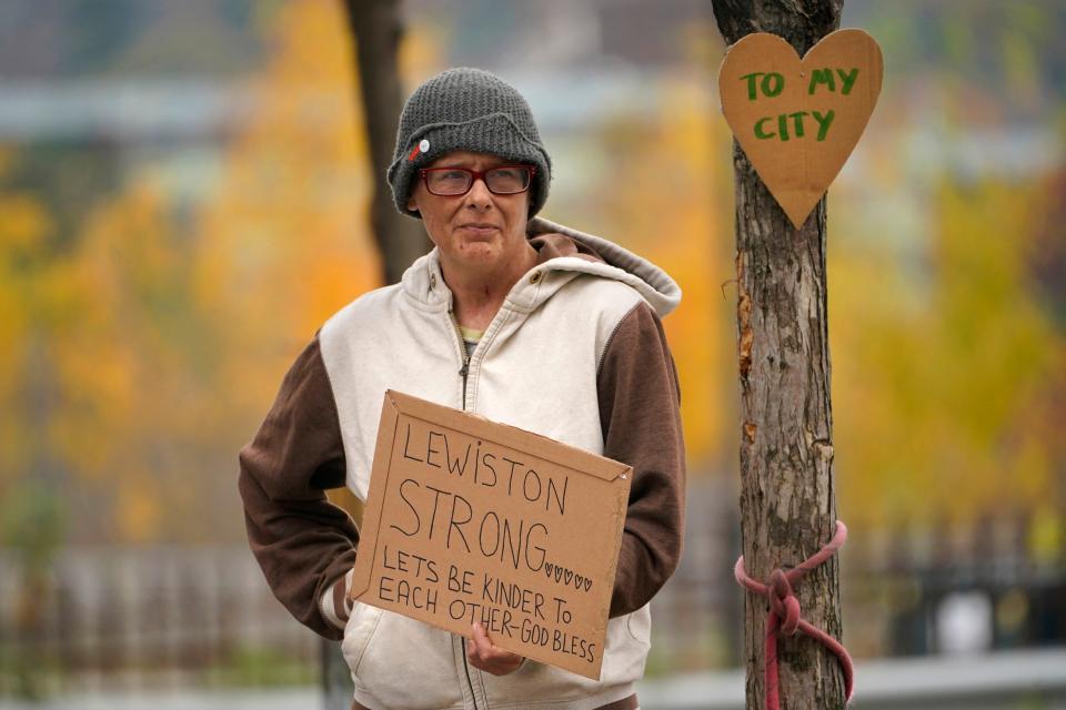 Jess Paquette expresses her support for her city in the wake of Wednesday's mass shootings at a restaurant and bowling alley, Thursday, Oct. 26, 2023, in Lewiston, Maine. Police continue their manhunt for the suspect. Authorities urged residents to lock themselves in their homes and schools announced closures on Thursday. (AP Photo/Robert F. Bukaty)