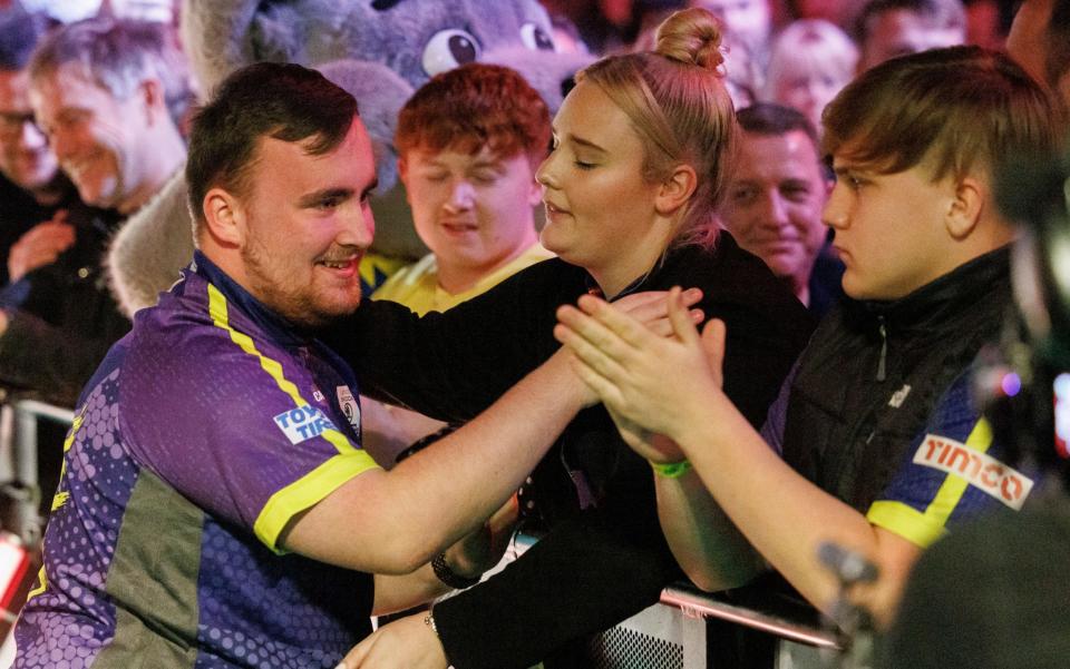 Luke Littler is greeted by friends and family before his semi-final triumph