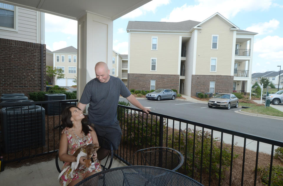 When Lina and Jimi Gibson moved into their 850-square-foot apartment in 2009, they figured they'd stay two years while they planned their wedding and saved for a house. Now, with the economy in another tailspin, they're on the fence. The couple can walk to restaurants and movies from their building in southwest Charlotte. They have a gym and a pool, and they don't have to mow the lawn or repair the roof. Mostly, they don't have to worry-like so many of their friends- that the housing market's slide isn't over. (Deidra Laird/Charlotte Observer/Tribune News Service via Getty Images)