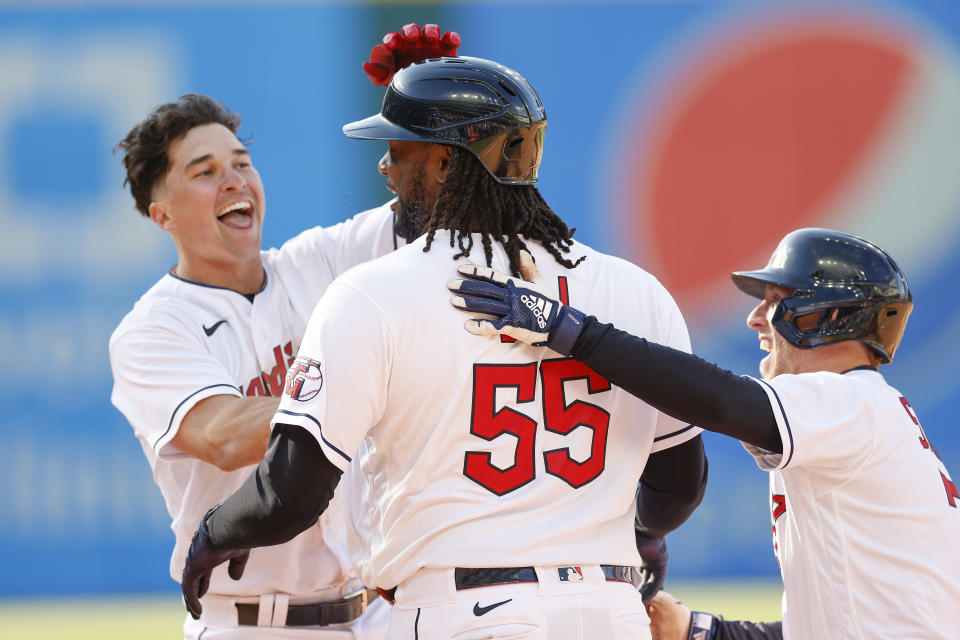 Cleveland Guardians' Josh Bell (55) celebrates with Will Brennan, left, and Myles Straw after hitting into a fielders choice that scored the game winning run against the Seattle Mariners during the 12th inning of a baseball game, Sunday, April 9, 2023, in Cleveland. (AP Photo/Ron Schwane)