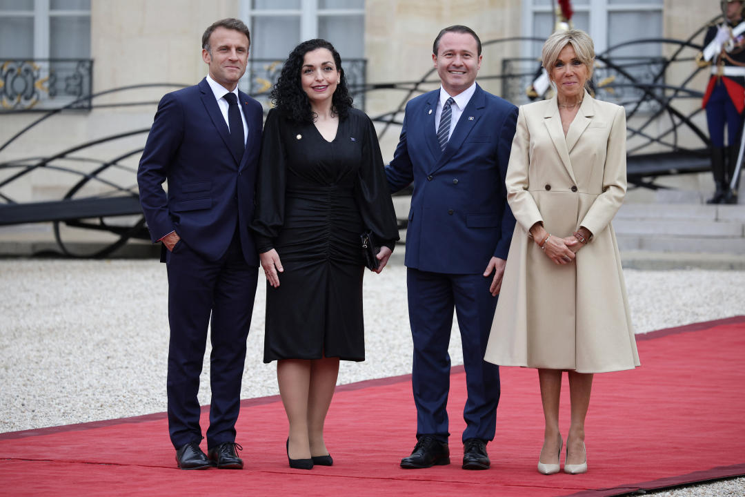 France's President Emmanuel Macron (L) and his wife Brigitte Macron (R) greet Kosovo's President Vjosa Osmani (2-L) her husband Prindon Sadriu (2-R) on arrival ahead of a reception for heads of state and governments ahead of the opening ceremony of the Paris 2024 Olympic Games, at the Elysee presidential palace in Paris, on July 26, 2024. (Photo by Valentine CHAPUIS / AFP) (Photo by VALENTINE CHAPUIS/AFP via Getty Images)