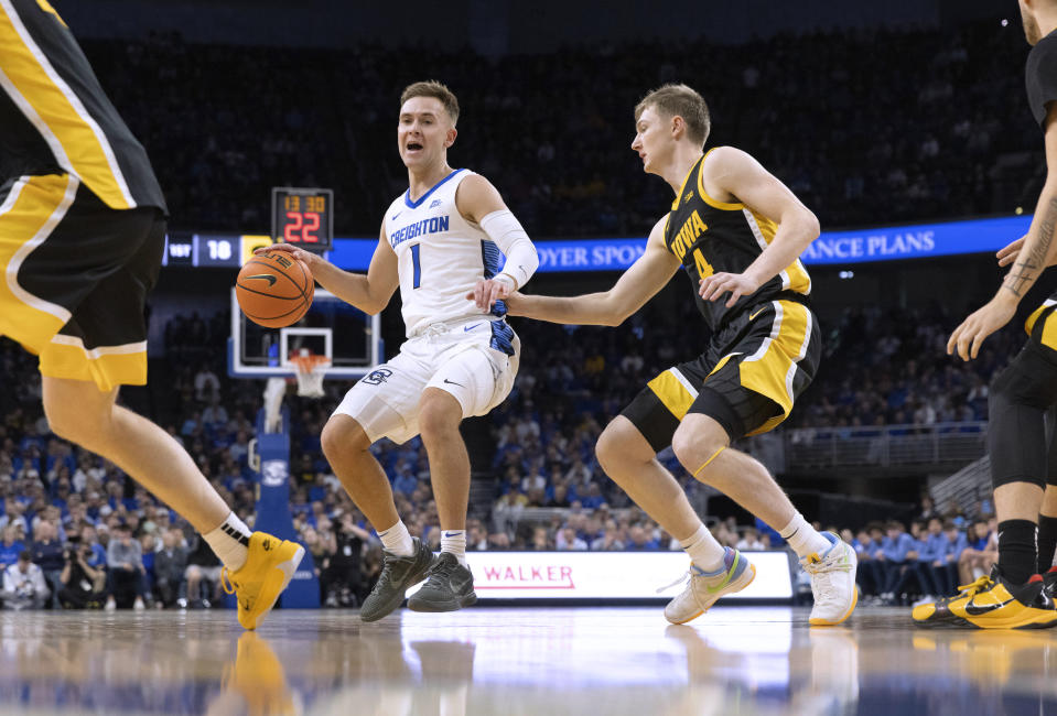 Creighton's Steven Ashworth (1) drives against Iowa's Josh Dix (4) during the first half of an NCAA college basketball game Tuesday, Nov. 14, 2023, in Omaha, Neb. (AP Photo/Rebecca S. Gratz)