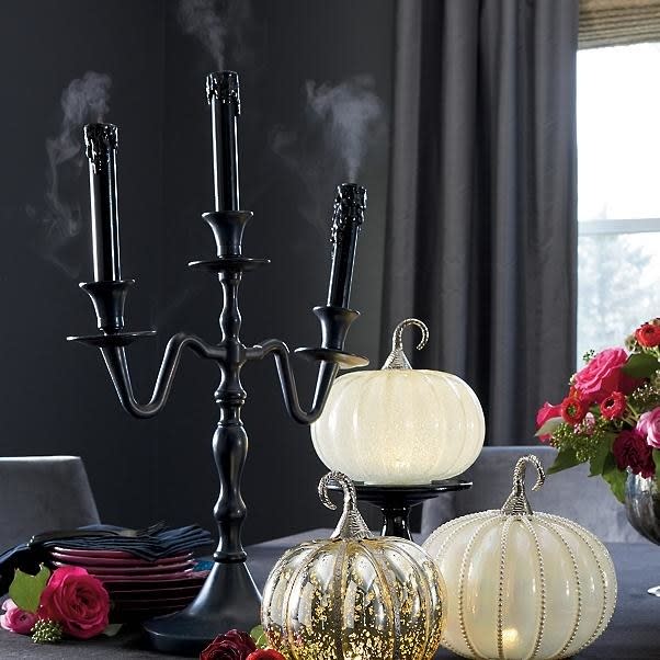 <p>This ghostly candelabra “burns” smoke (aka misting water) on its own for a perpetually haunted vibe.</p> <p><strong>Shop now:</strong> Grandin Road Misting Haunted Candelabra, $139. <a rel="nofollow noopener" href="https://www.grandinroad.com/misting-haunted-candelabra/1187504" target="_blank" data-ylk="slk:grandinroad.com;elm:context_link;itc:0;sec:content-canvas" class="link ">grandinroad.com</a></p>