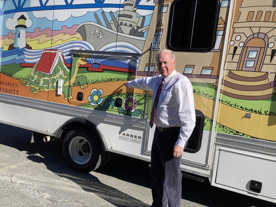 Mayor Paul Coogan shows off the city's new book mobile.