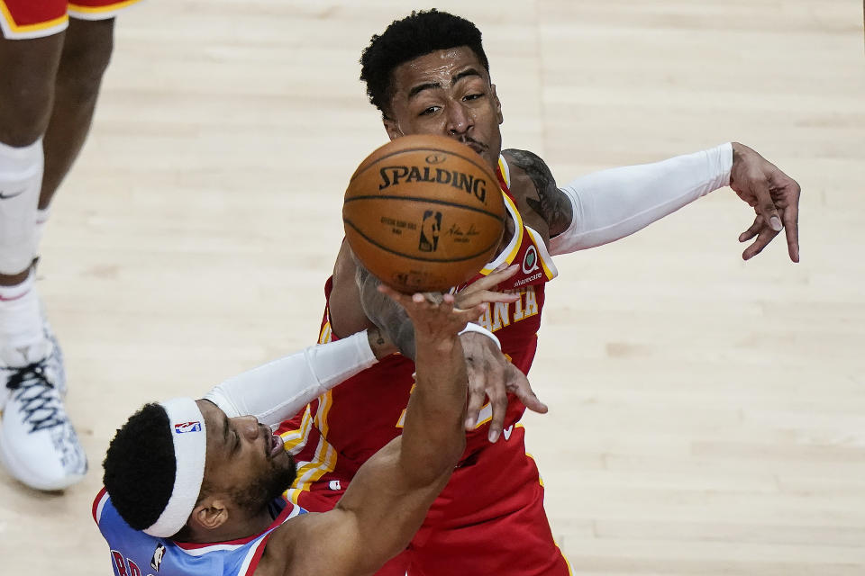 Brooklyn Nets guard Bruce Brown (1) is fouled by Atlanta Hawks forward John Collins (20) during the first half of an NBA basketball game Wednesday, Jan. 27, 2021, in Atlanta. (AP Photo/Brynn Anderson)