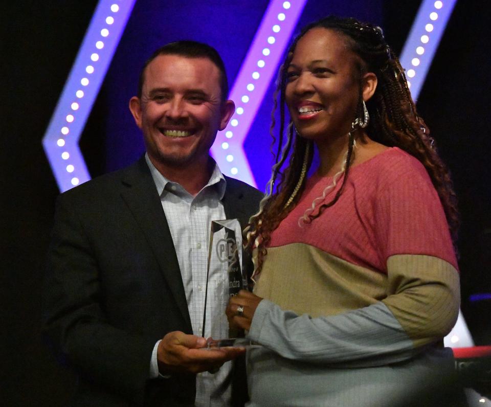 LaChandra Hooper, right, wins the Campus Coordinator of the Year award during the PIE appreciation dinner at Faith Baptist Church on Tuesday. Dr. Donny Lee, left, superintendent of Wichita Falls ISD, presents the award.