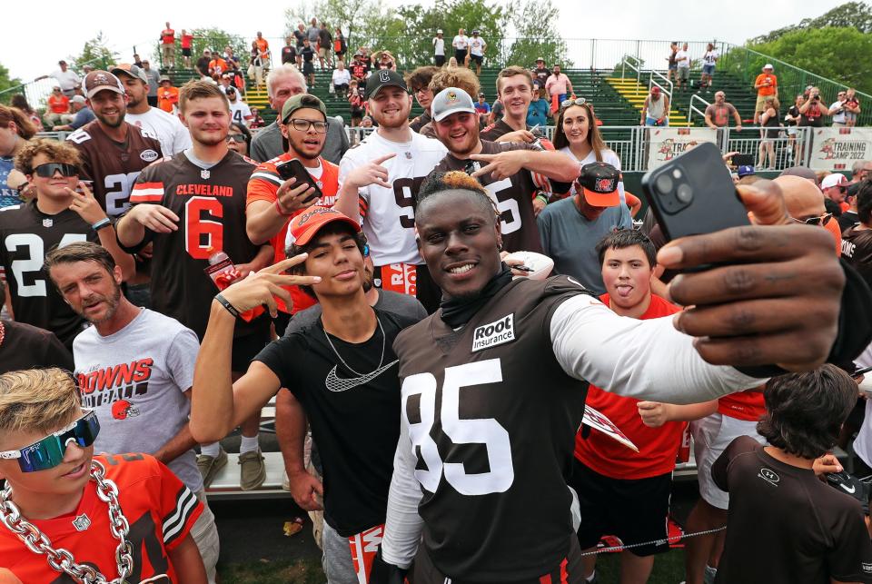Cleveland Browns tight end David Njoku snaps a selfie with fans after the NFL football team's football training camp in Berea on Monday.