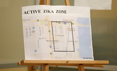 A map is seen of the active Zika zone as Hillary Clinton visits the Borinquen Health Care Center in Miami, August 9, 2016. REUTERS/Chris Keane