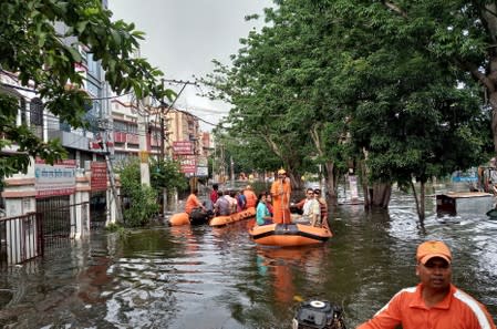 Rescue members evacuate people from a flood-affected neighbourhood in Patna