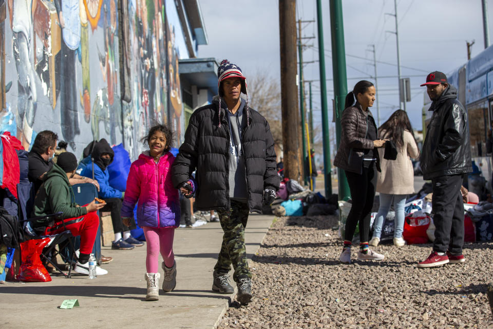 Venezuelan migrants Juan Tovar and his 7-year-old daughter, Arianny Tovar, walk near Sacred Heart Church in El Paso, Texas.