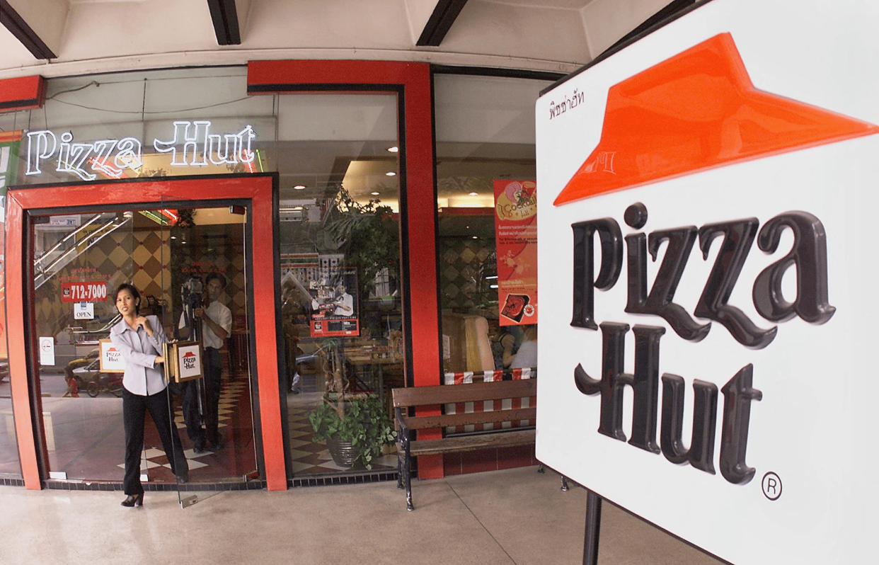 Front Exterior of a Pizza Hut, Bangkok, Person Opening the Door