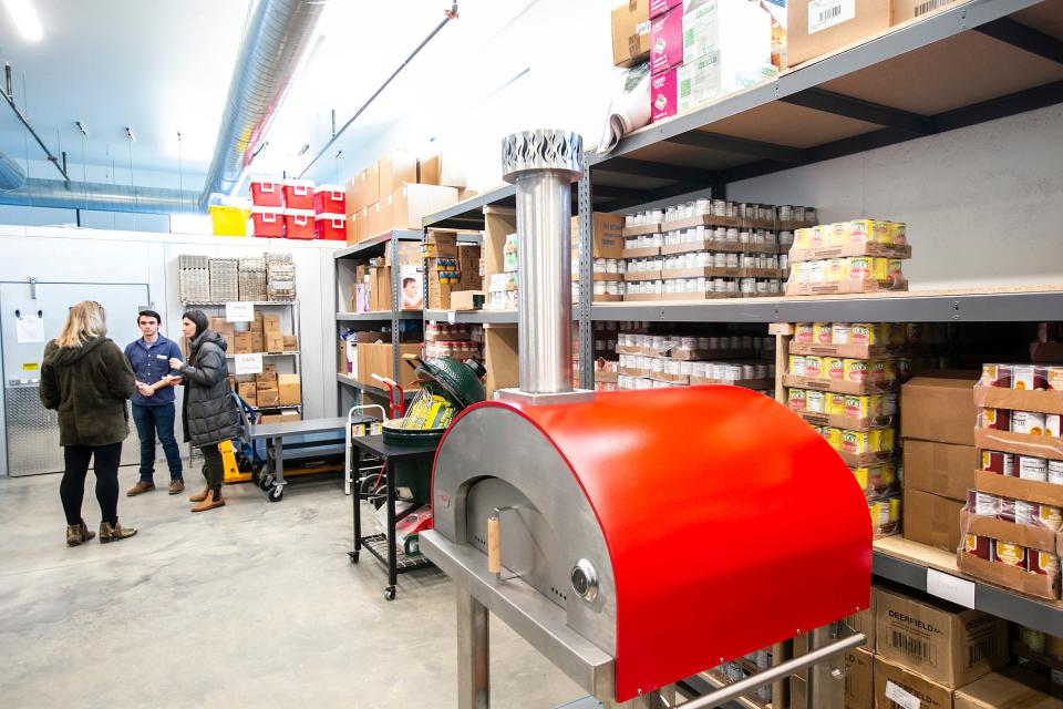 Guests tour the facility during a grand opening event for the Coralville Community Food Pantry, Thursday, April 6 at 804 13th Avenue.