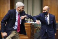 Sen. Bill Cassidy, R-La., left, elbow bumps Labor Secretary Eugene Scalia before a Senate Finance Committee hearing on "COVID-19/Unemployment Insurance" on Capitol Hill in Washington on Tuesday, June 9, 2020. (Caroline Brehman/CQ Roll Call/Pool via AP)