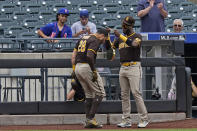 San Diego Padres' Jurickson Profar, right, puts a large necklace over Tommy Pham's head after Pham hit a solo home run during the first inning of a baseball game against the New York Mets at Citi Field, Sunday, June 13, 2021, in New York. (AP Photo/Seth Wenig)