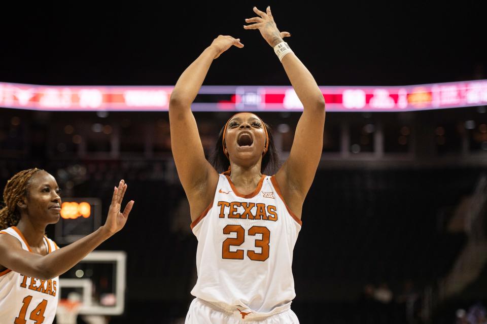 Aaliyah Moore celebrates the Longhorns' 70-53 win over Iowa State in Tuesday night's Big 12 Tournament championship game. She was battling sickness but still produced 14 points and six rebounds in 26 minutes.