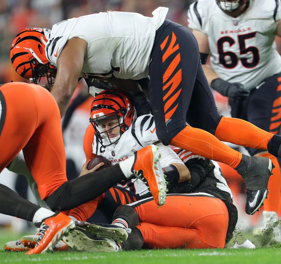 Bengals quarterback Joe Burrow is sacked by Browns linebacker Deion Jones during the second half Monday, Oct. 31, 2022, in Cleveland.