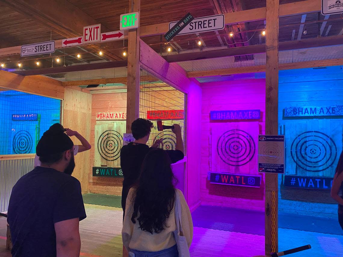 Bellingham Axe employee Thomas Weinzierl shows patrons how to safely throw an ax on Friday, July 1, 2022. Owner Matthew Kinney opened The Axe Bar above the activity venue, which is located in the basement of 1414 Cornwall Ave.