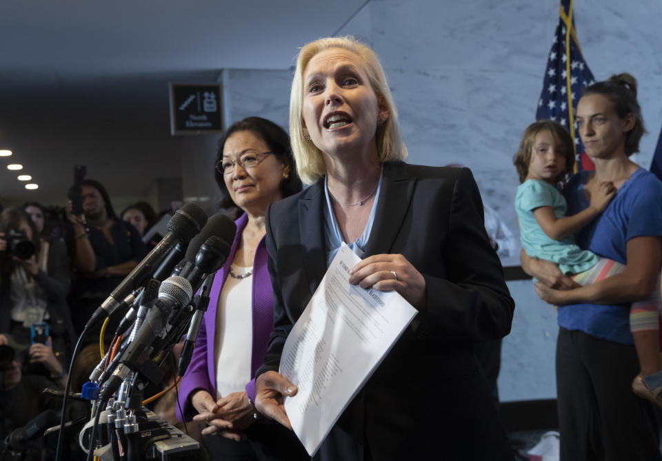 Sen. Kirsten Gillibrand, D-N.Y., with Sen. Mazie Hirono, D-Hawaii, left, joined by former students from Holton Arms School, speaks to reporters in support of professor Christine Blasey Ford, who is accusing Supreme Court nominee Brett Kavanaugh of a decades-old sexual attack, during a news conference on Capitol Hill in Washington, Thursday, Sept. 20, 2018. (AP Photo/J. Scott Applewhite)