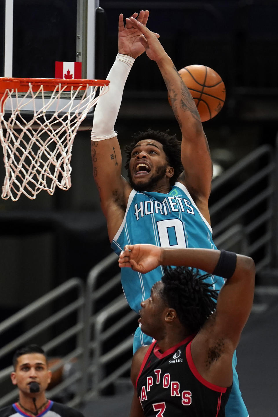 Charlotte Hornets forward Miles Bridges (0) can't handle a pass after getting past Toronto Raptors forward OG Anunoby (3) during the second half of an NBA basketball game Saturday, Jan. 16, 2021, in Tampa, Fla. (AP Photo/Chris O'Meara)