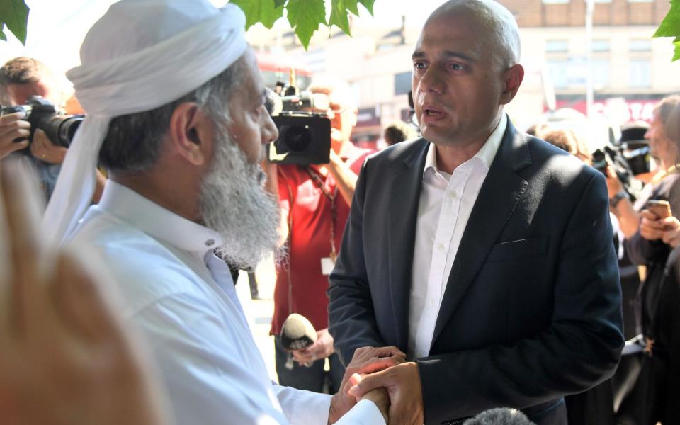 Sajid Javid meets a member of the local community in Finsbury Park - Credit: Victoria Jones/PA